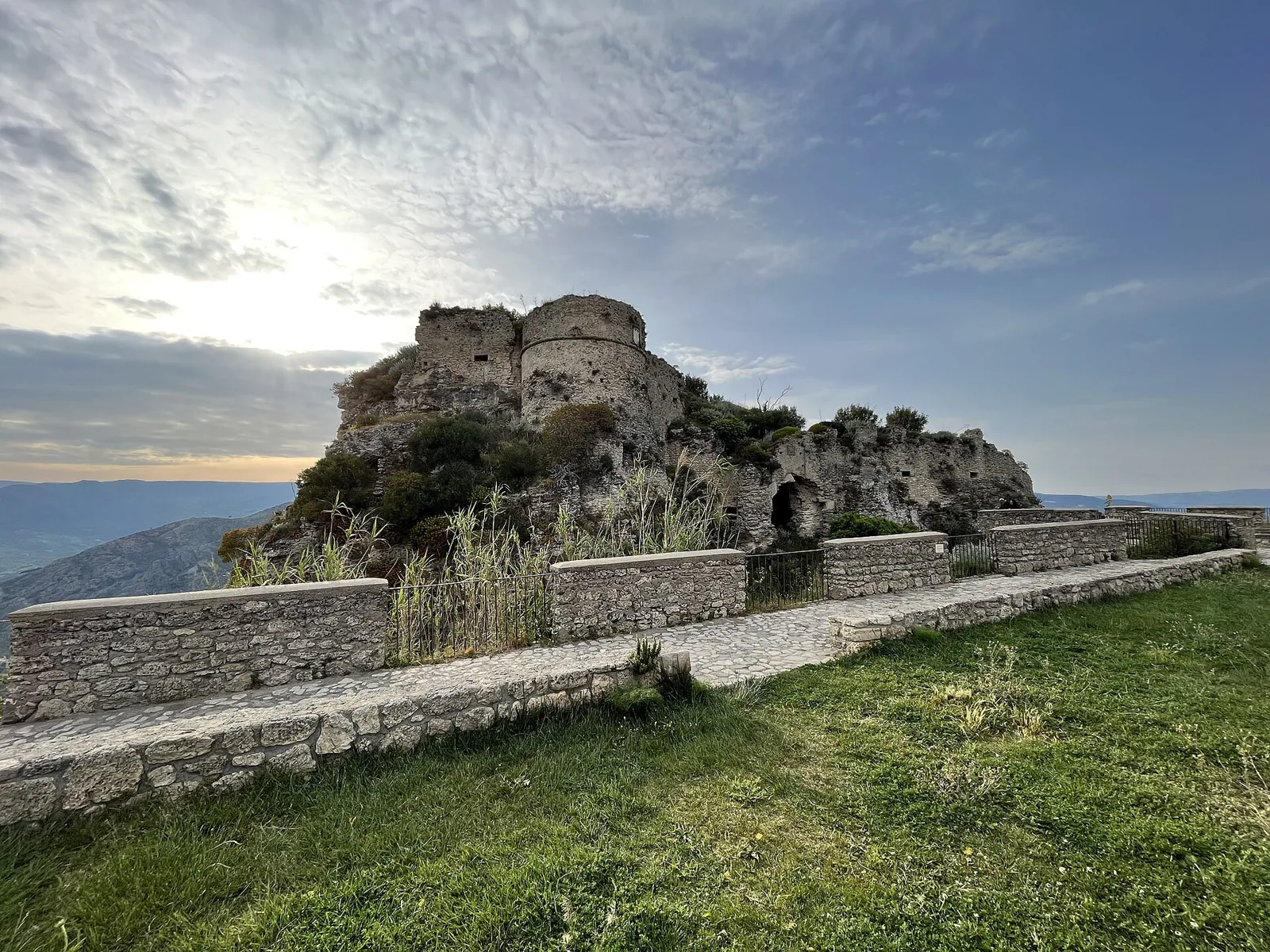 Ruins of Gerace castle with mountain and valley views.