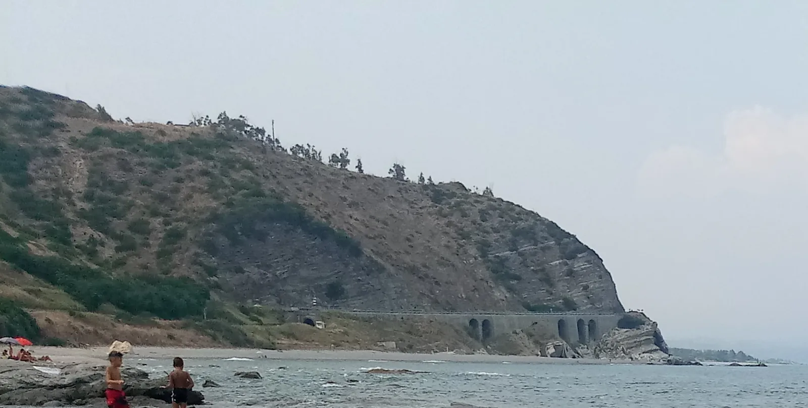 Capo Bruzzano cliff above a rocky beach in Calabria
